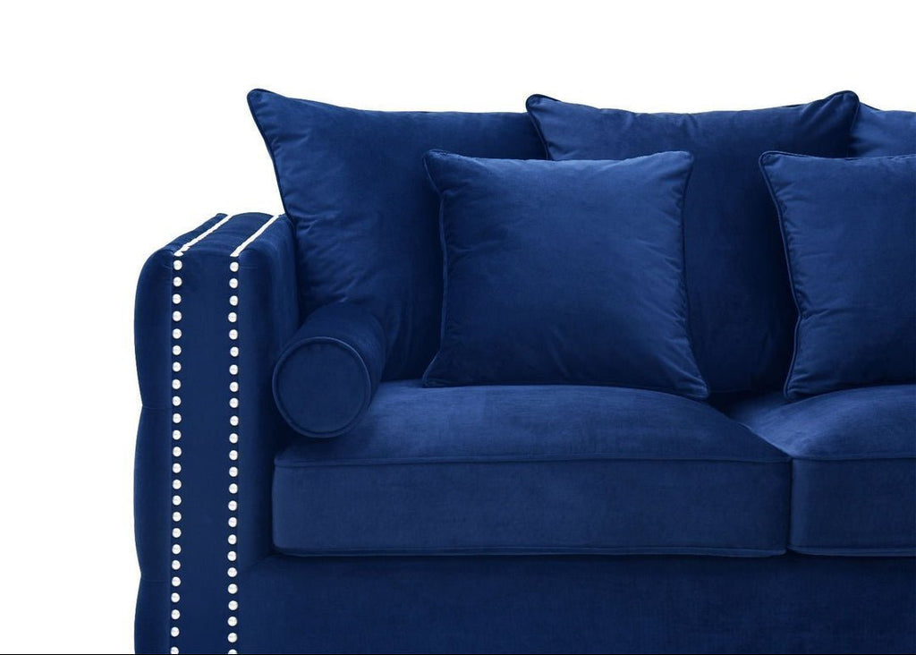 Blue sofa with decorative pillows on a white background