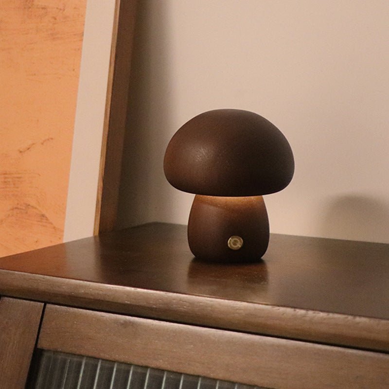 A collection of mushroom-shaped wood lamps in various colors illuminated, displayed on a shelf.