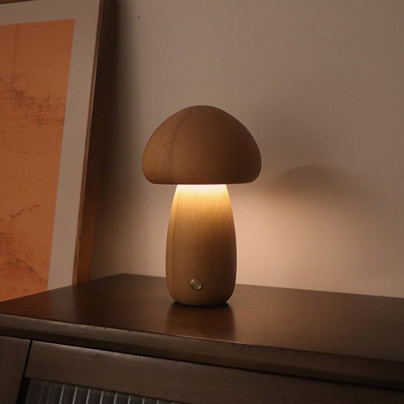 A collection of mushroom-shaped wood lamps in various colors illuminated, displayed on a shelf.
