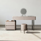 Beige vanity table with mirror and stool in a minimalistic room.