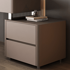 Modern nightstand with two drawers and a television on top in a dimly lit room.