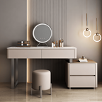 Modern vanity with round mirror, light fixtures, and decorative items against a gray wall.