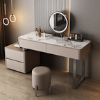 Modern vanity table with mirror and stool in a stylish room.