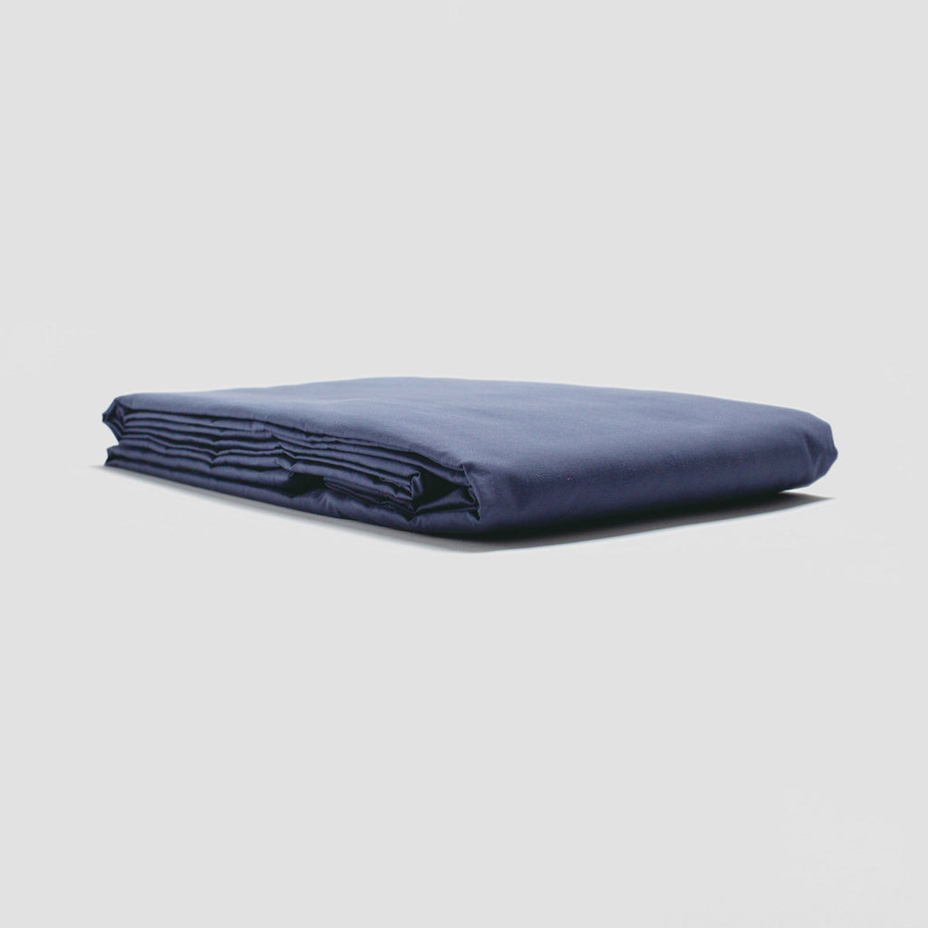 Folded navy blue fabric on a light gray background
