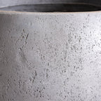 Close-up of a textured gray concrete planter