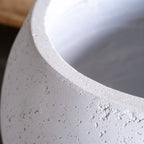 Close-up of a textured concrete surface with a smooth white edge.