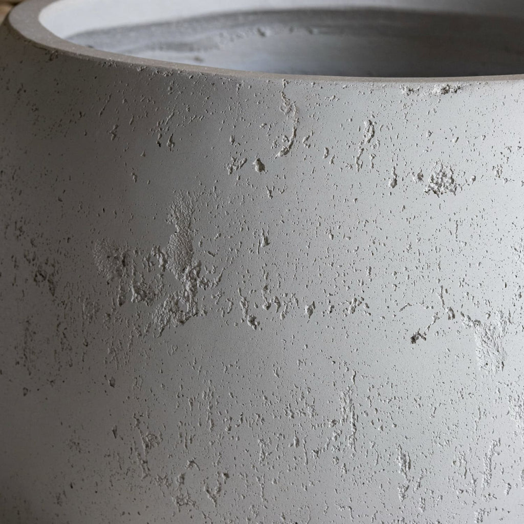 Close-up of a textured gray concrete planter