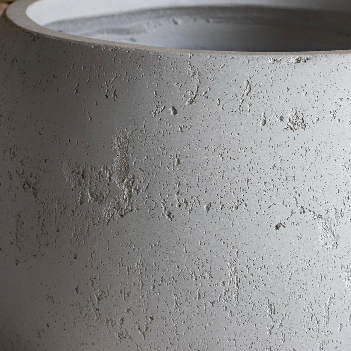 Close-up of a textured gray concrete planter
