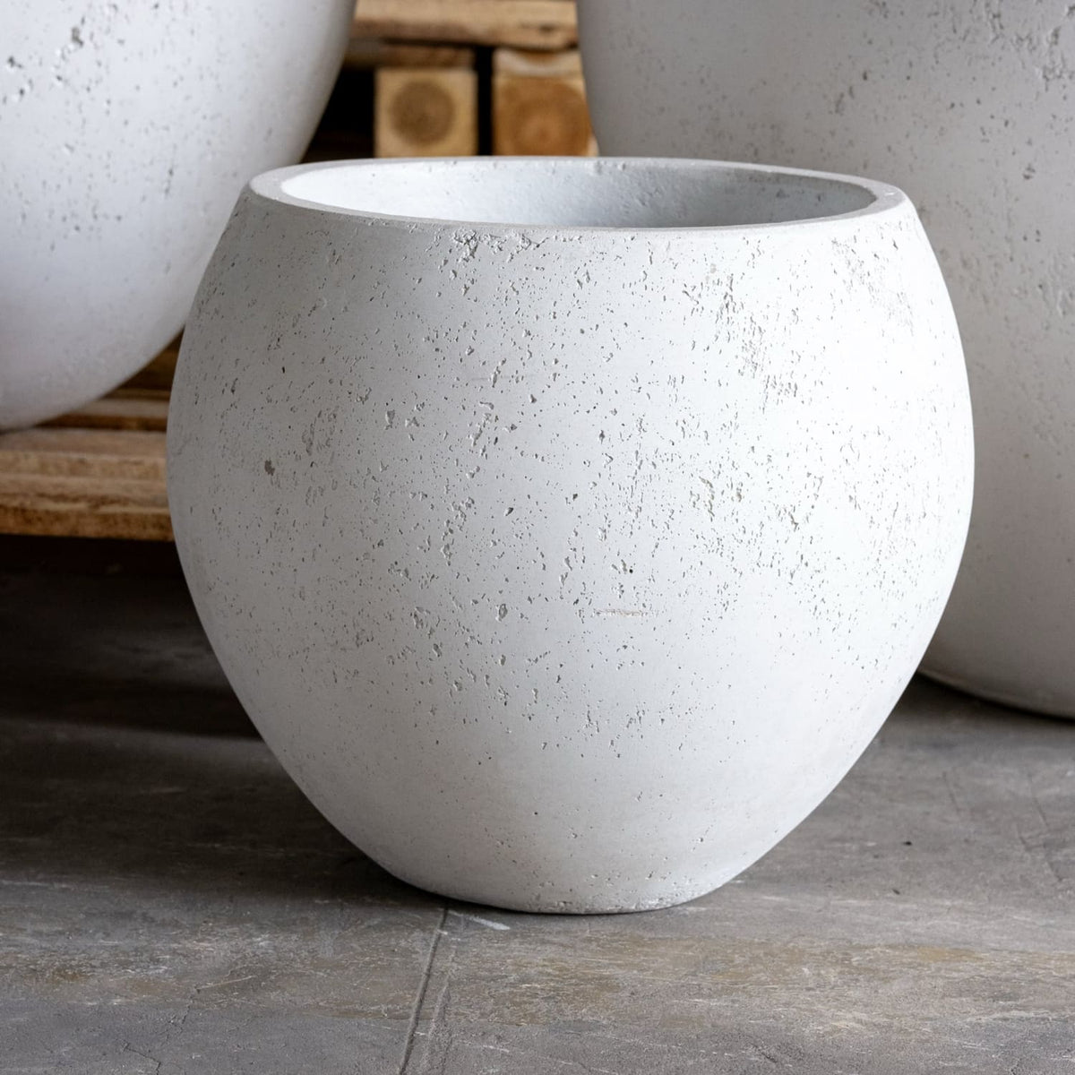 Concrete planters on a wooden surface