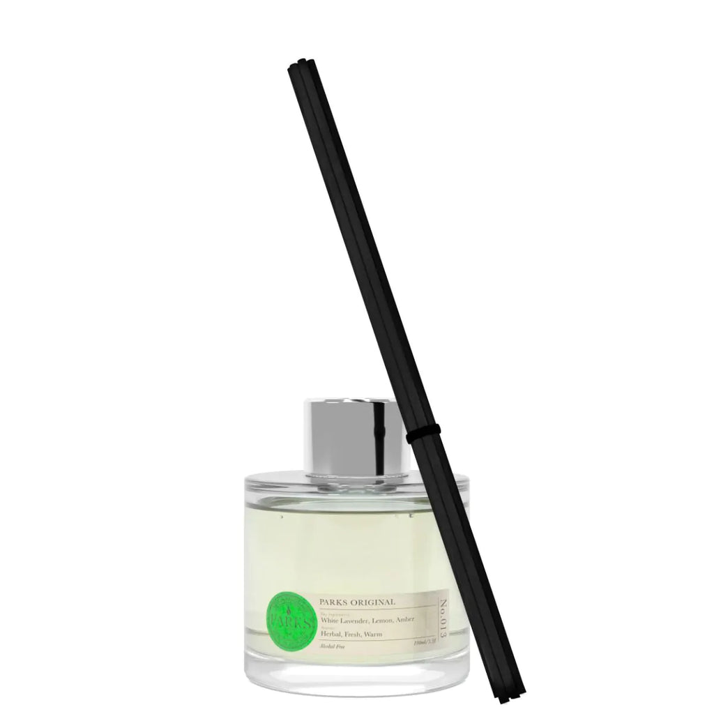 Clear diffuser bottle with black reed stick on a white background