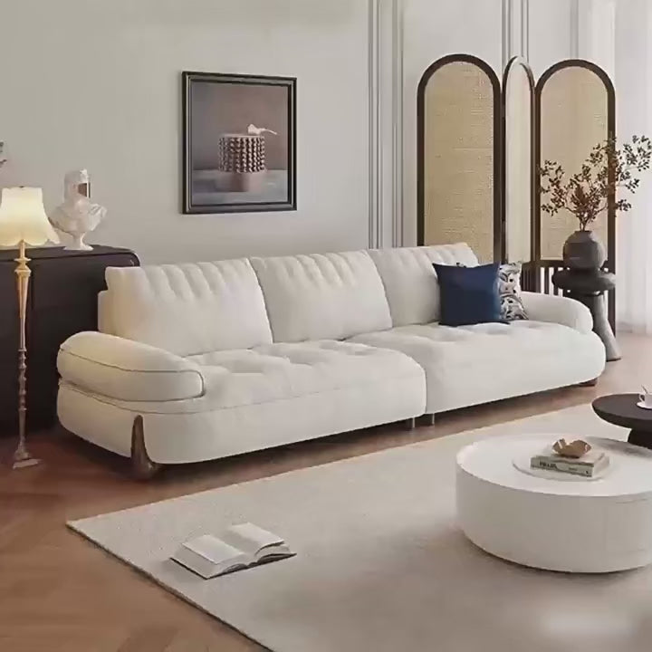 Modern living room with a white sofa, round coffee table, and decorative elements video