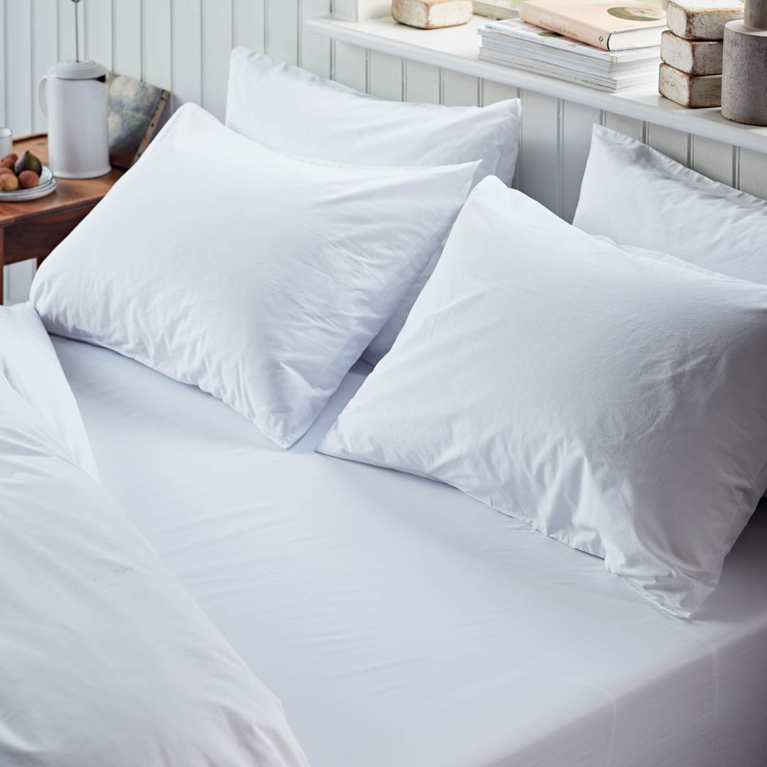 White pillows on a bed with a neutral background