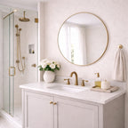 Bathroom with white vanity, round mirror, and gold fixtures