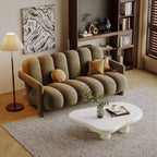 Modern living room with a beige sofa, white coffee table, and decorative items.