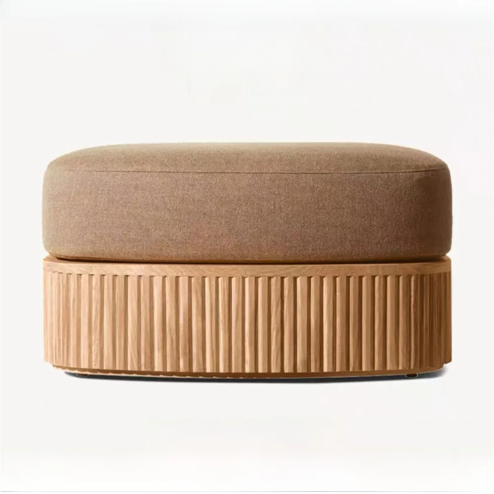 Brown ottoman with textured base on a white background