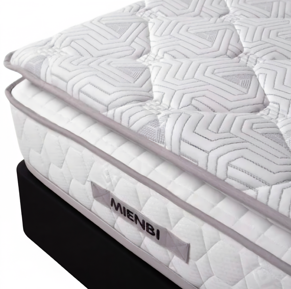 A close-up studio shot of a mattress corner showing a white quilted mattress topper and side panel with the brand name MIENBI, resting on a black mattress base against a white background.