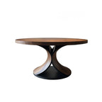 Round wooden table with a black base on a white background