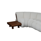 White sofa with a wooden side table on a white background