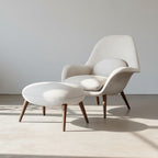 Modern chair and ottoman set with wooden legs on a light background