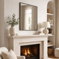 Cozy living room with a fireplace, mirror, and decorative items.