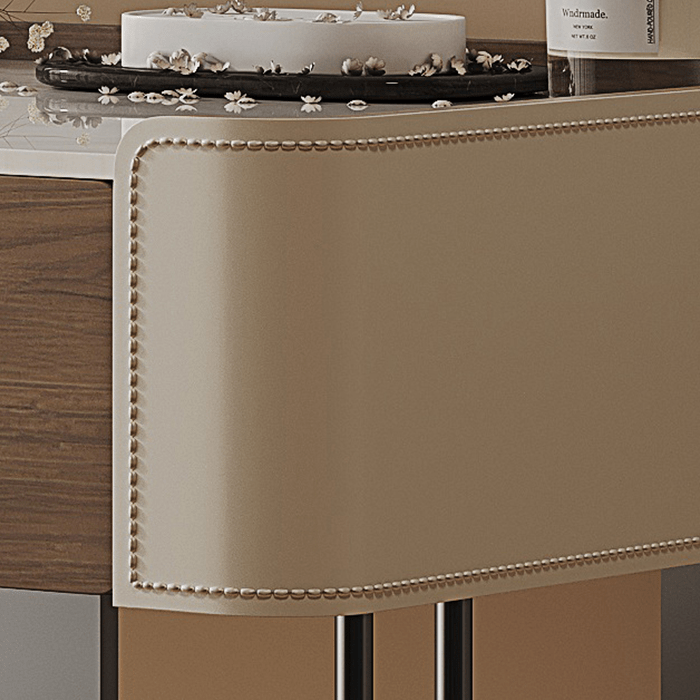 Close-up of a decorative table with a cake and bottle on a wooden surface.