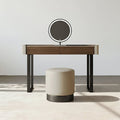 Dressing table with a round mirror and stool on a light background