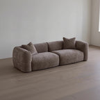 Brown sofa with cushions in a minimalistic room