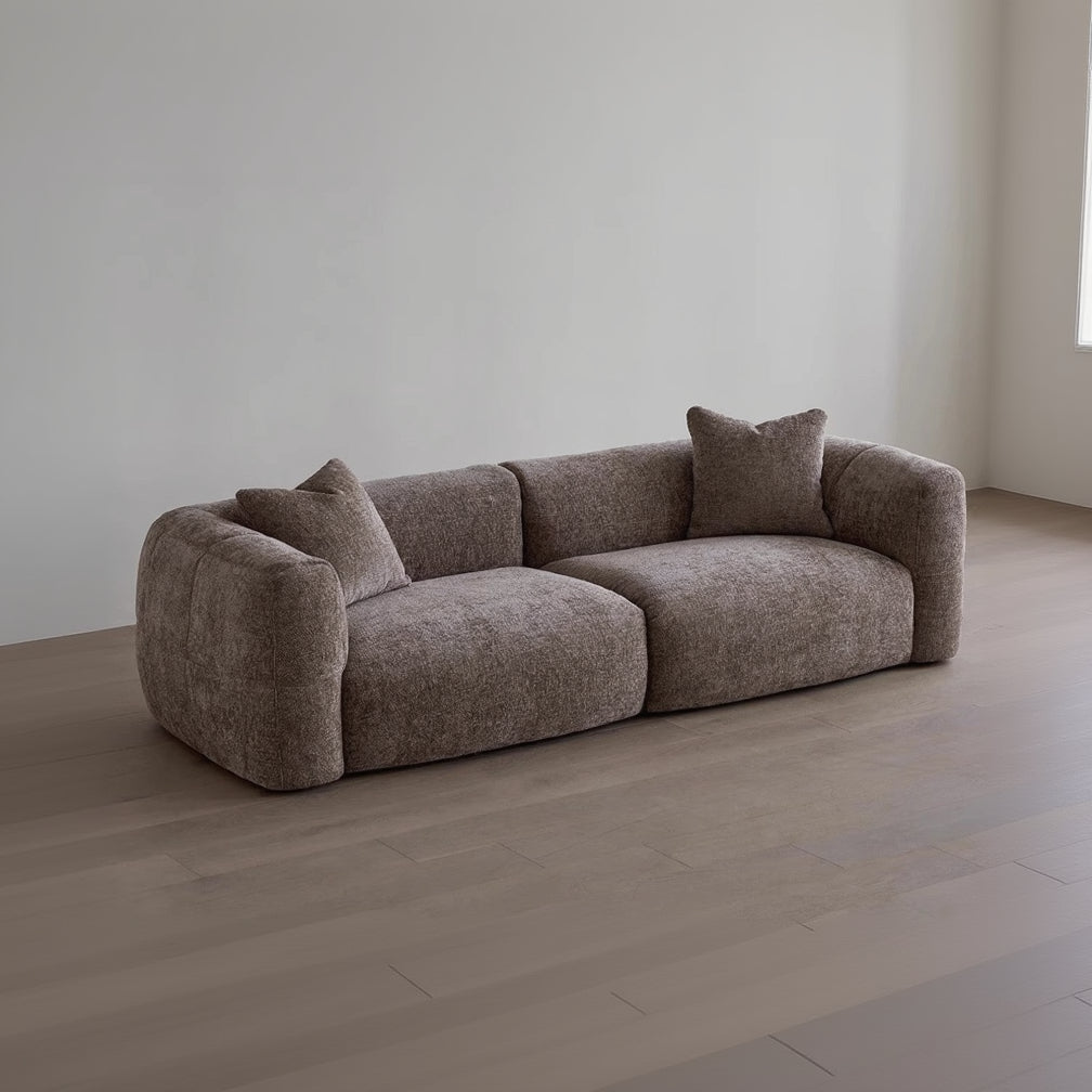 Brown sofa with cushions in a minimalistic room