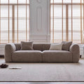Gray sofa with cushions in a room with wooden blinds