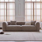 Gray sofa with cushions in a room with wooden blinds