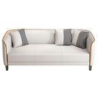 White sofa with black and white checkered pillows on a white background