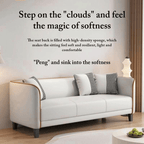 White sofa with decorative pillows in a room setting, featuring text about the sofa's comfort.