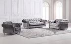 Gray velvet sofa set in a room with white walls and large windows.