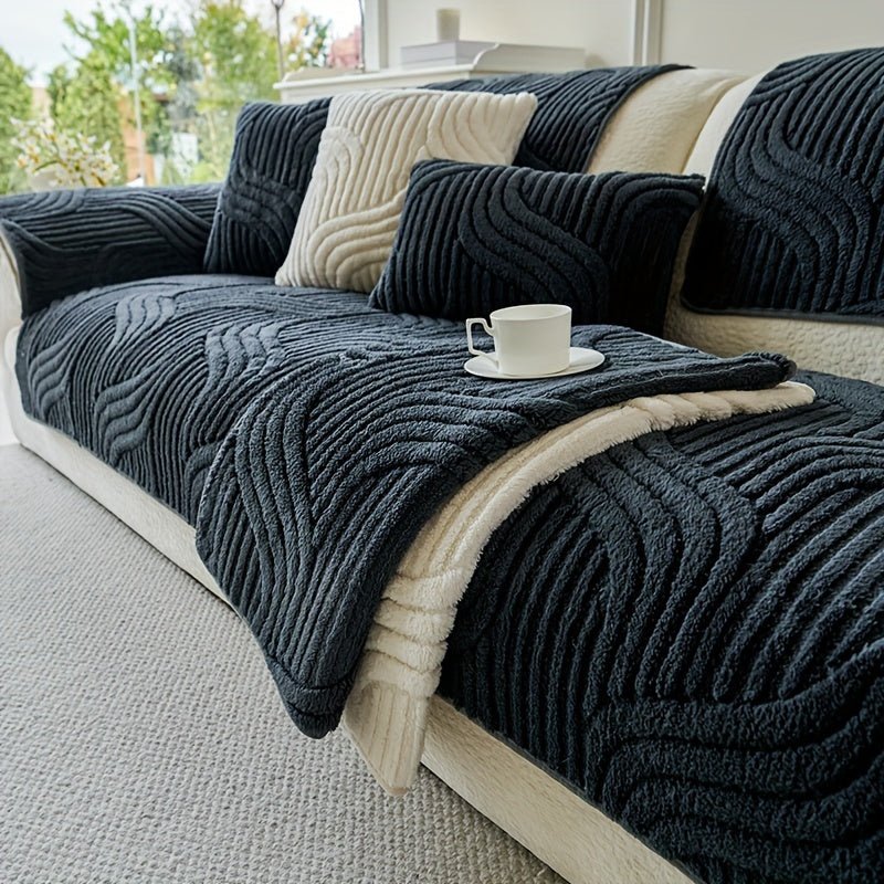 Dark blue textured sofa cover on a light-colored sofa with a cup and saucer on a small table.