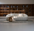 White sofa in a room with wooden shelves and décor