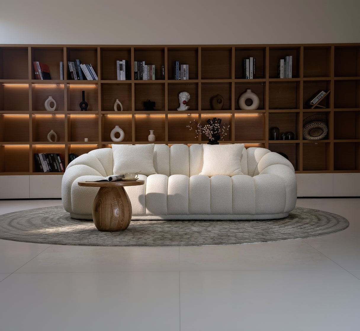 White sofa in a room with wooden shelves and décor