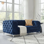 Blue tufted sofa with a gold pillow and white blanket in a bright room.