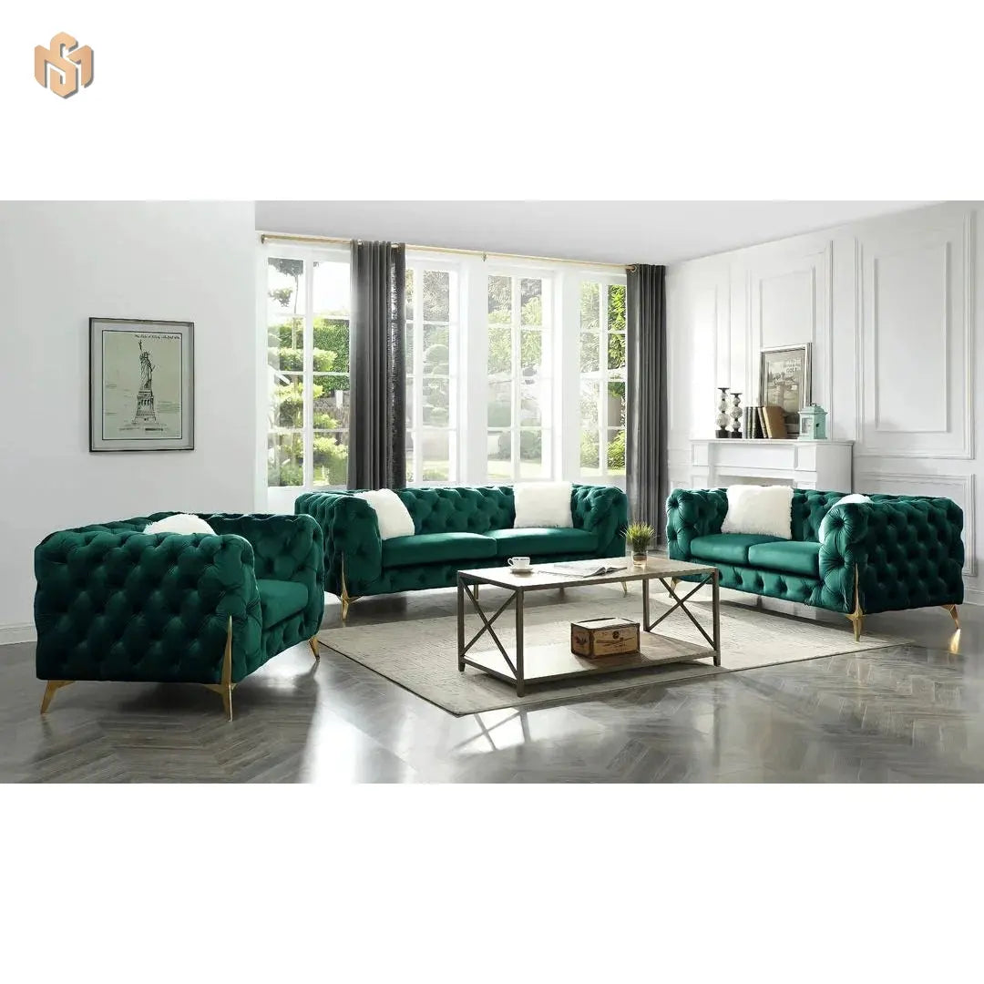 Green velvet sofa set in a modern living room with large windows.