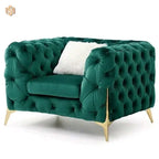 Green tufted sofa with gold legs on a white background