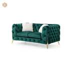 Green tufted sofa with a white pillow on a white background