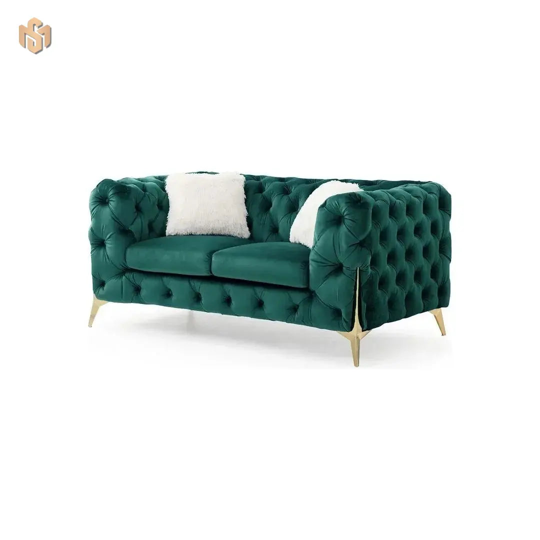 Green tufted sofa with a white pillow on a white background
