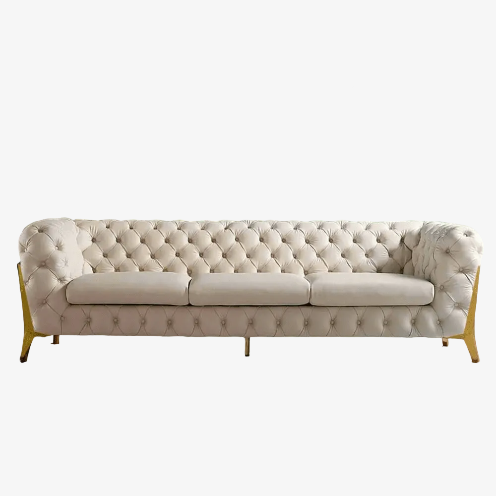 Beige tufted sofa with gold legs on a white background