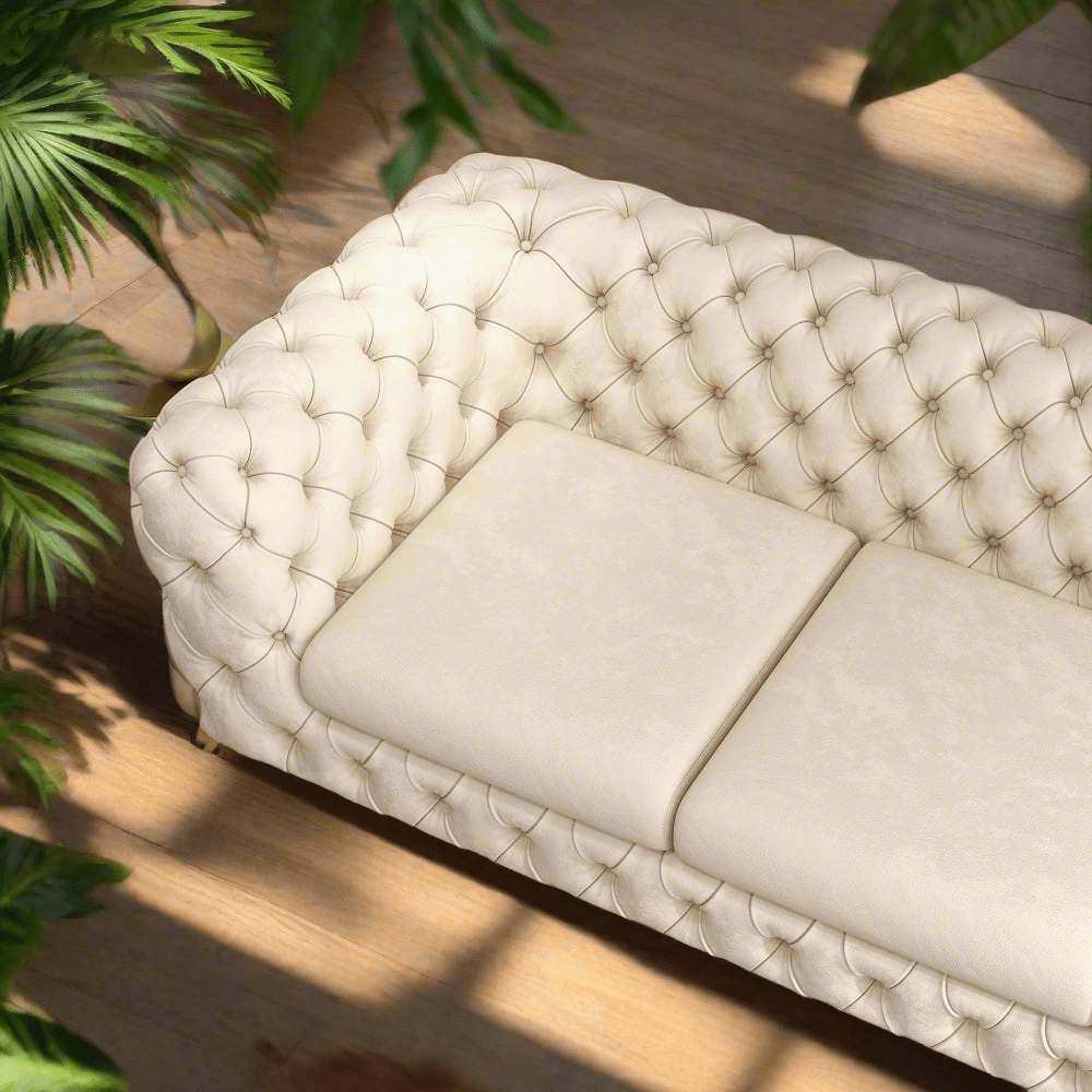 Beige tufted sofa with a plant in the background