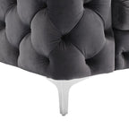 Gray tufted headboard with white legs on a white background