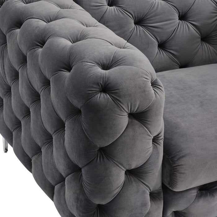 Gray tufted velvet sofa with a close-up of the buttoned texture.