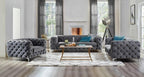 Modern living room with gray tufted sofa set and coffee table.