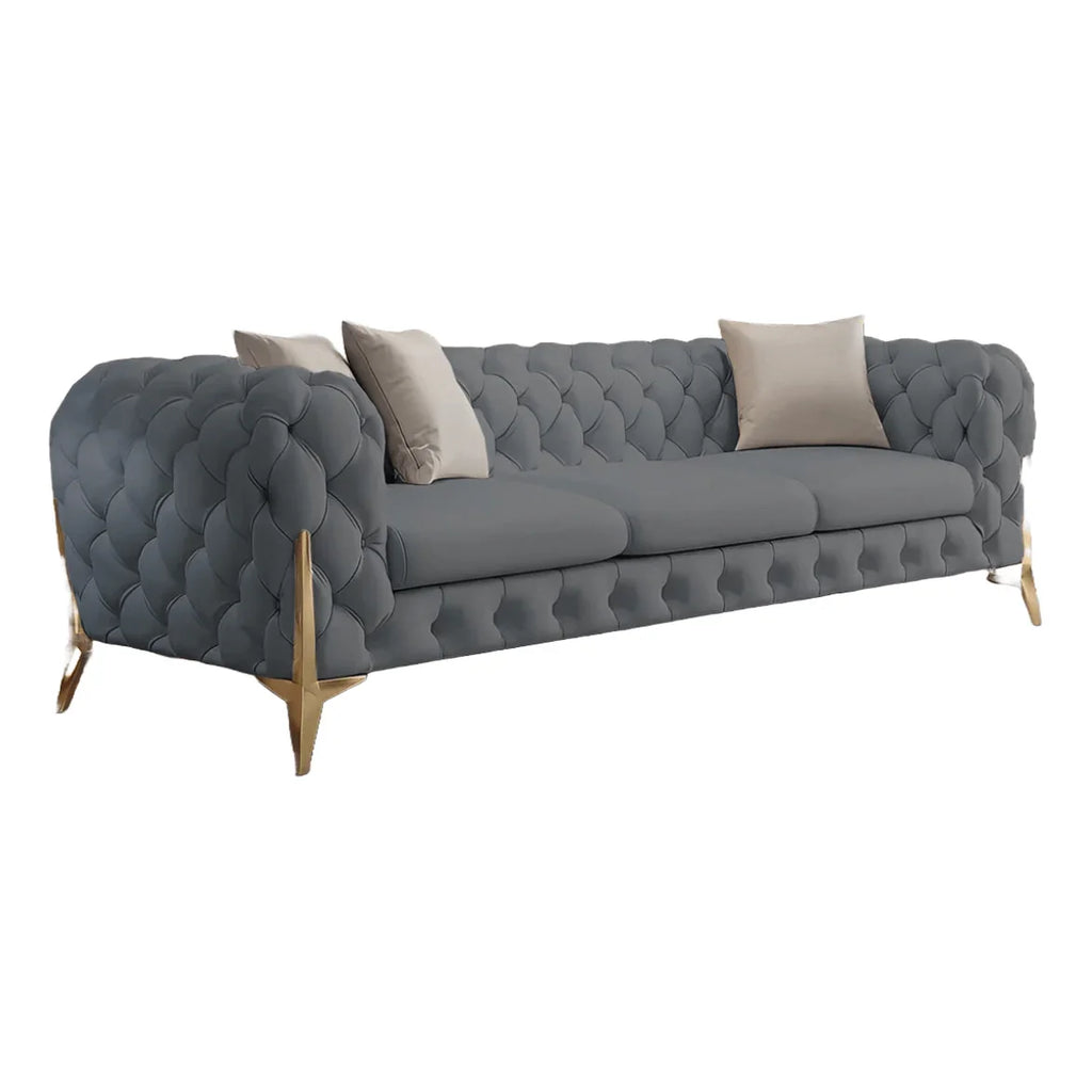 Gray tufted sofa with beige cushions on a white background