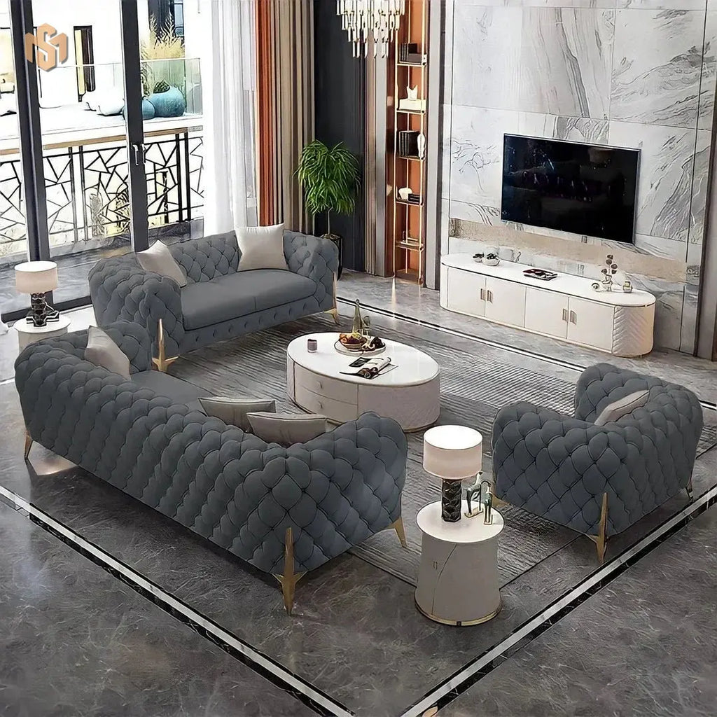 Modern living room with gray tufted sofa, armchair, and coffee table.