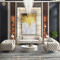 Modern living room with gray tufted sofa, armchairs, and a chandelier.
