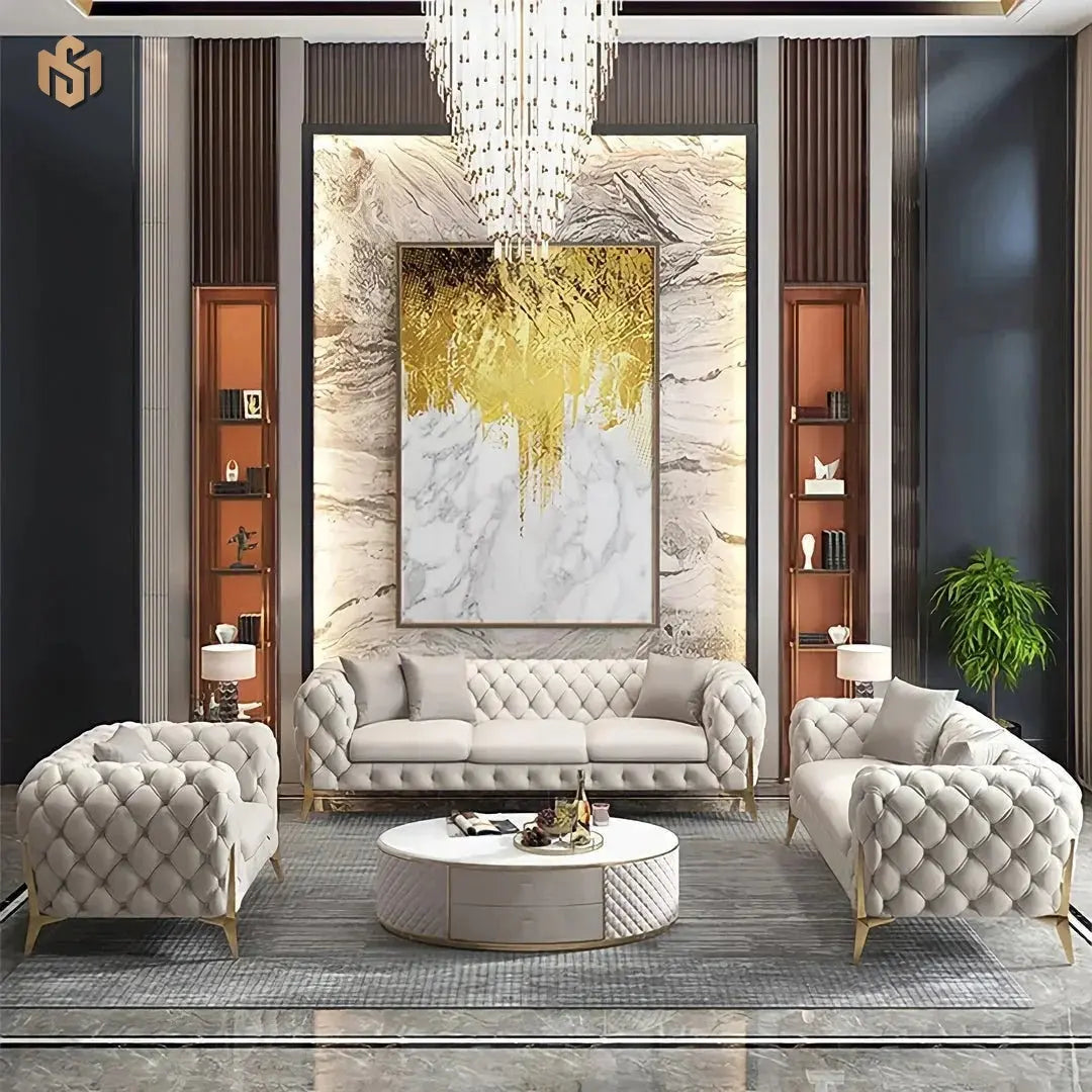 Modern living room with gray tufted sofa, armchairs, and a chandelier.
